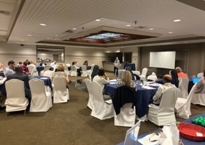 Sue Lanza delivers a speech in front of a group of attendees.