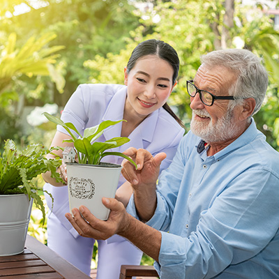 resident and nurse planting plants