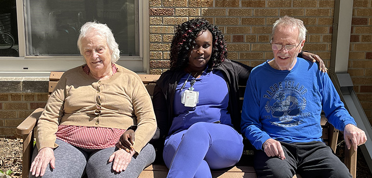A nurse sitting with residents at Douglas County