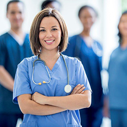 nurse with arms crossed in front of other nurses