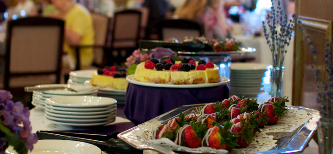 Dessert table with cheesecake and chocolate covered strawberries