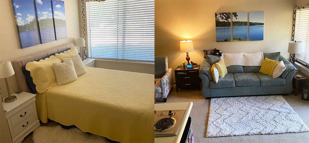 Yellow covered bed in bedroom and gray sofa in living area of assisted living apartments