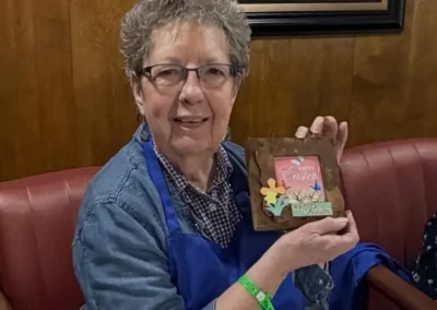 A resident shows off a photo frame she's decorated for Easter.