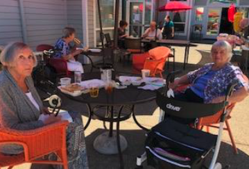 Residents Enjoying A BBQ Outside Together.