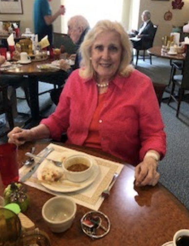 A lady eating dinner.