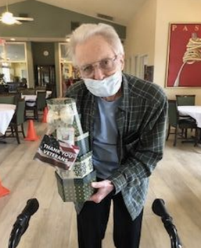 A Resident Who Is A Veteran Accepting A Gift.