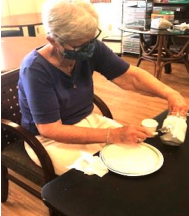 A Resident With A Mask Preparing Food