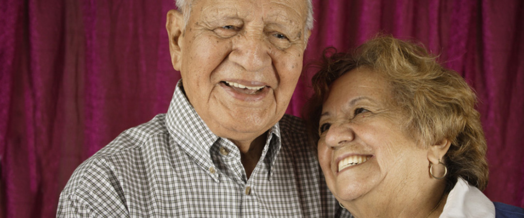 Two seniors smiling at each other.
