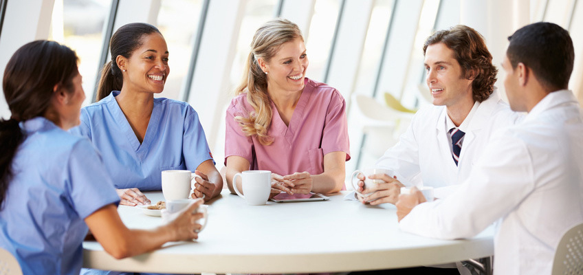 A group of healthcare workers sitting around a table 