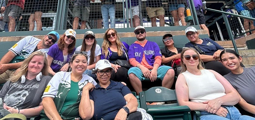 Several staff members from Lowry Hills in the stands at a Colorado Rockies game