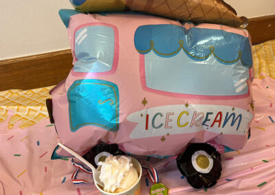 A cup of ice cream next to a baloon at Lowry Hills