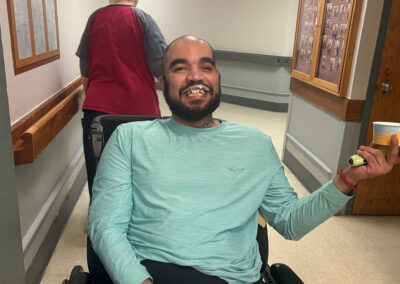 A resident smiling with a cup of ice cream at Lowry Hills