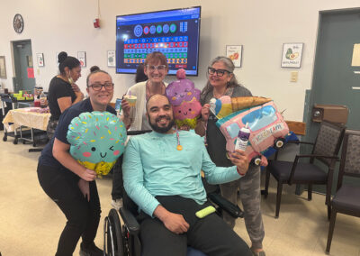 Nurses smiling with a resident at Lowry Hills
