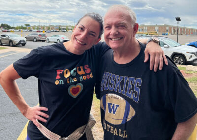 Two people smiling outside of Lowry Hills