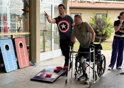 Employees and residents playing corn hole at Lowry Hills