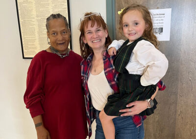 Two women and a child smiling at Lowry Hills