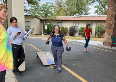 Employees playing corn hole outside at Lowry Hills