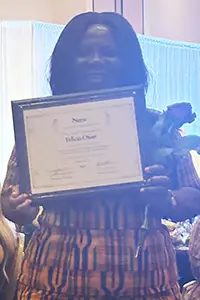 Felicia O holding an award