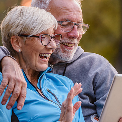 A senior couple talking into a cellphone