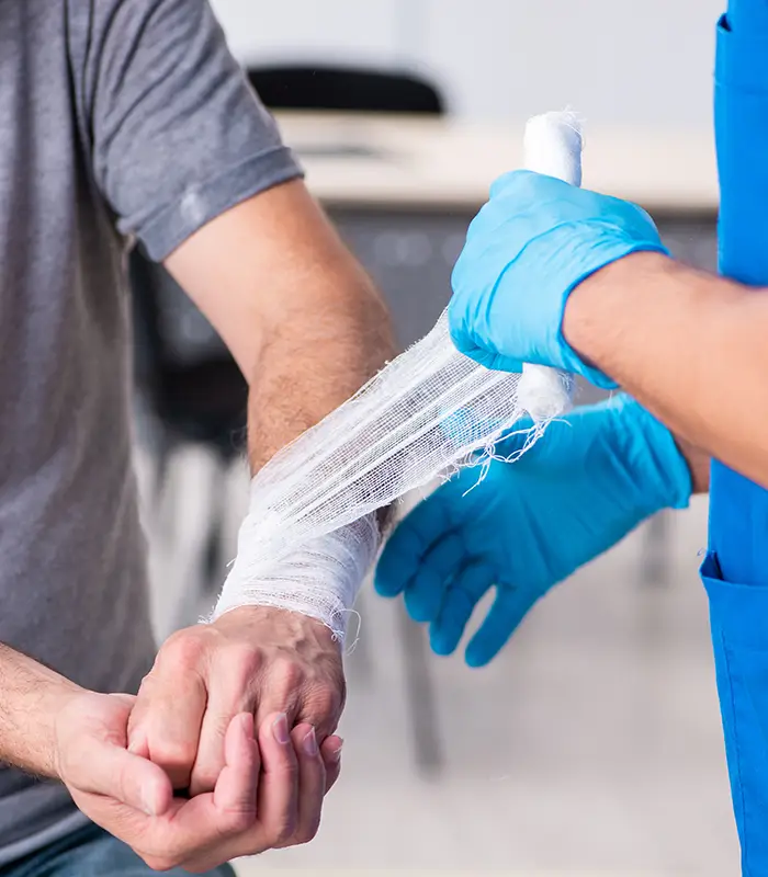 Wound care bandage being wrapped around man's arm.