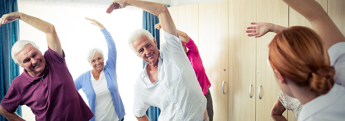 A few residents smiling while engaging in one of the senior care activities