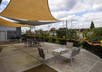 A patio with tables and chairs outside of Oak Ridge