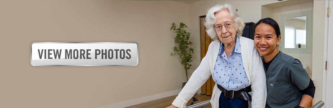 Oakridge-gallery-1080x350-3 An elderly woman doing physical therapy at Oak Ridge and a button that says "View More Photos"