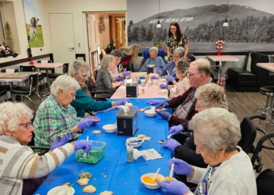 Residents sitting at a table together at Elm Crest