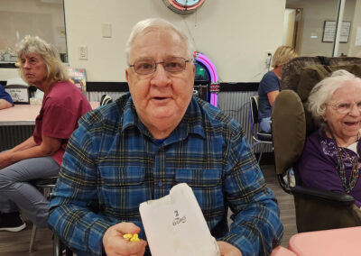 An elderly man sitting at a table at Elm Crest