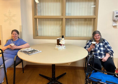 Two ladies eating treats at Elm Crest