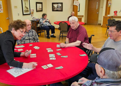 Residents playing cards together at Elm Crest
