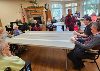Residents playing games around a table at Elm Crest