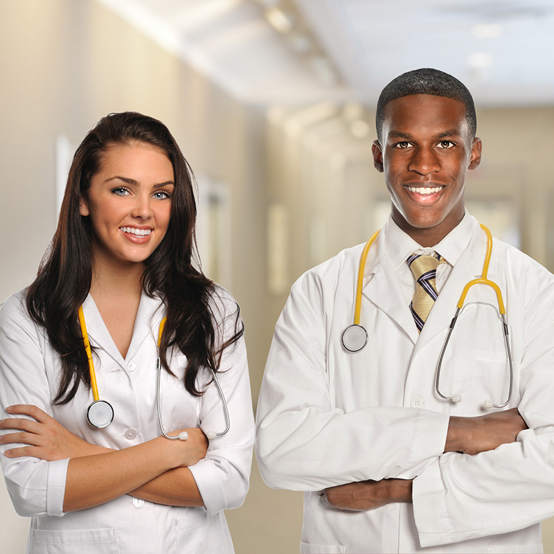 Male and female medical staff wearing white scrubs