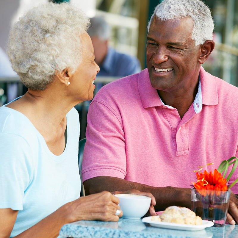 elderly couple dining outside together