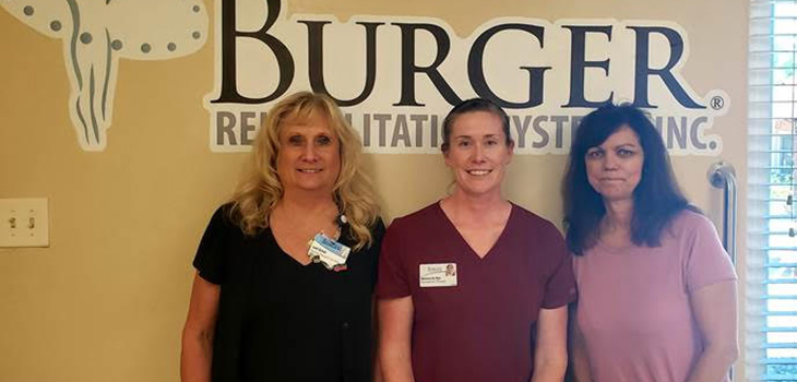 three nurses standing together smiling