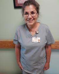 Carol Rardon in blue scrubs