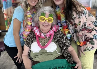 Older woman in luau clothes with younger women
