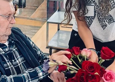 A staff member brings a resident flowers