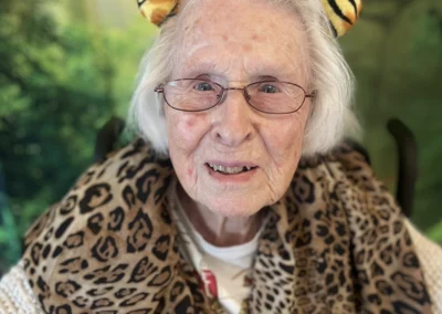 A resident wearing tiger ears in front of a jungle backdrop