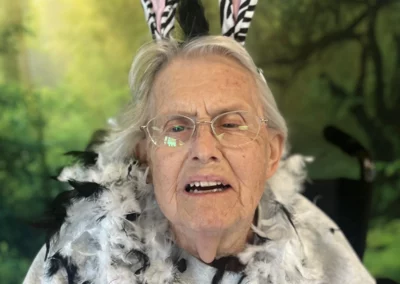 A resident wearing zebra-print bunny ears in front of a jungle backdrop