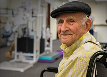 A senior in a wheelchair in a rehabilitation room.