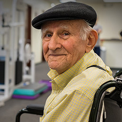 A senior in a wheelchair in a rehabilitation room.