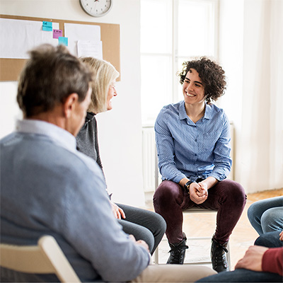A group of people sitting in a circle talking