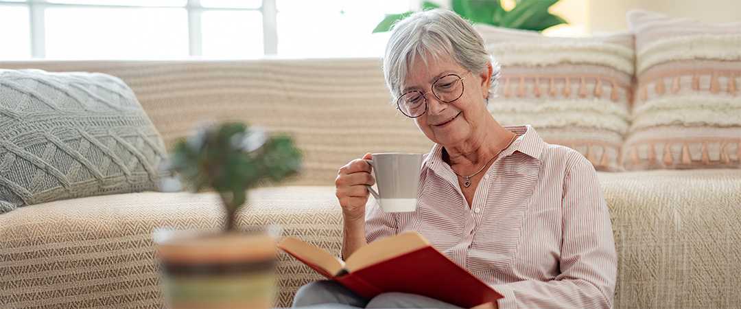 a lady enjoying coffee and a book for her daily routine