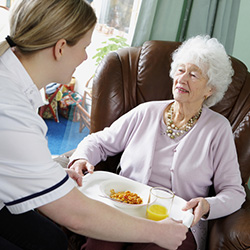 Older Woman Being Served a Meal