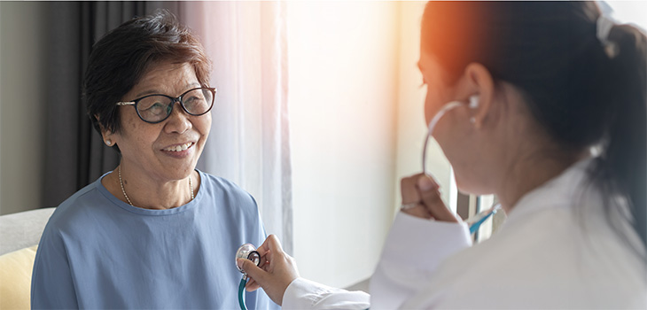 A nurse checking a nurses heartbeat