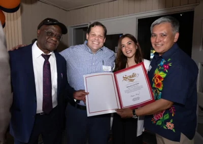 Staff members with a recognition letter from Senator Angelique Ashby