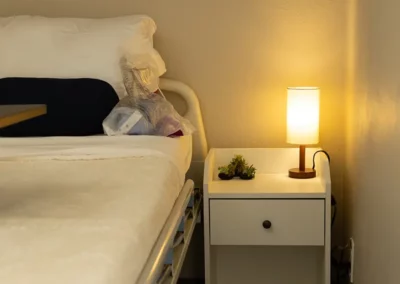 A small nightstand next to a patient bed