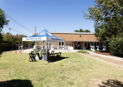 The front lawn of Quiescence with a pop up canopy tent and tables set up