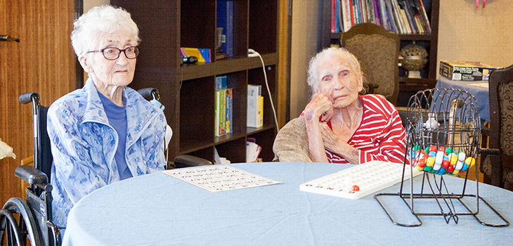 Two residents playing bingo.